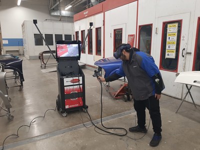 Lincoln Tech student practices painting a car door using SimSpray at the East Windsor, CT campus.